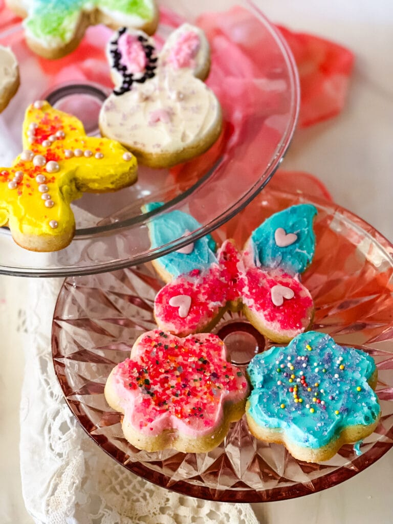 Spring cookies decorated with buttercream icing including butterflies, bunnies, and flowers.