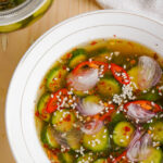Top view of Asian Pickled cucumbers in a white bowl.