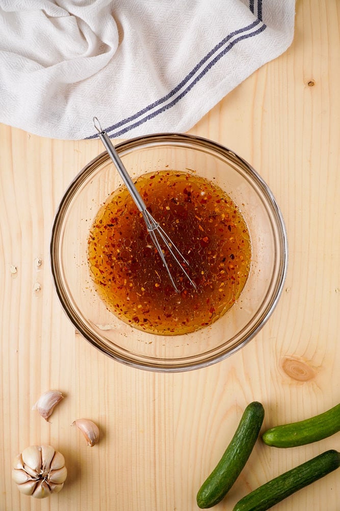 Whisking together the seasonings for cucumbers.