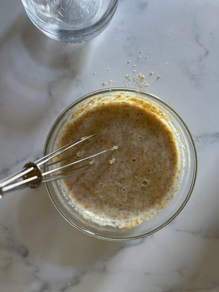 Whisking together the flax egg buttermilk mixture.