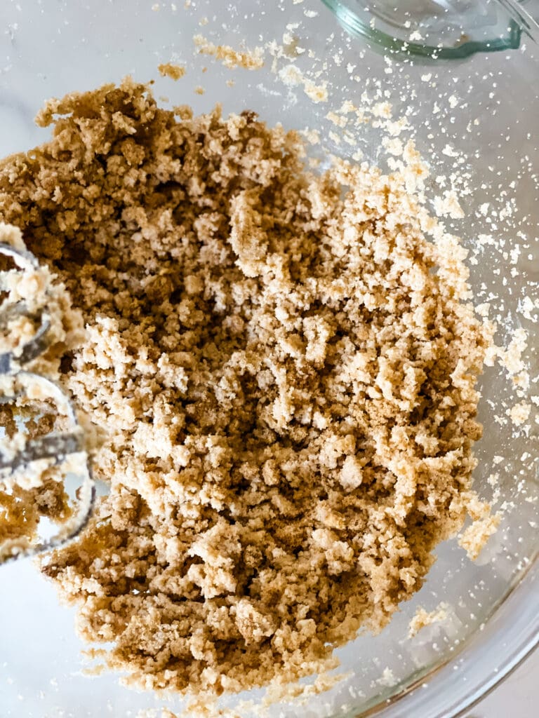 Mixing together the sugars and fat.