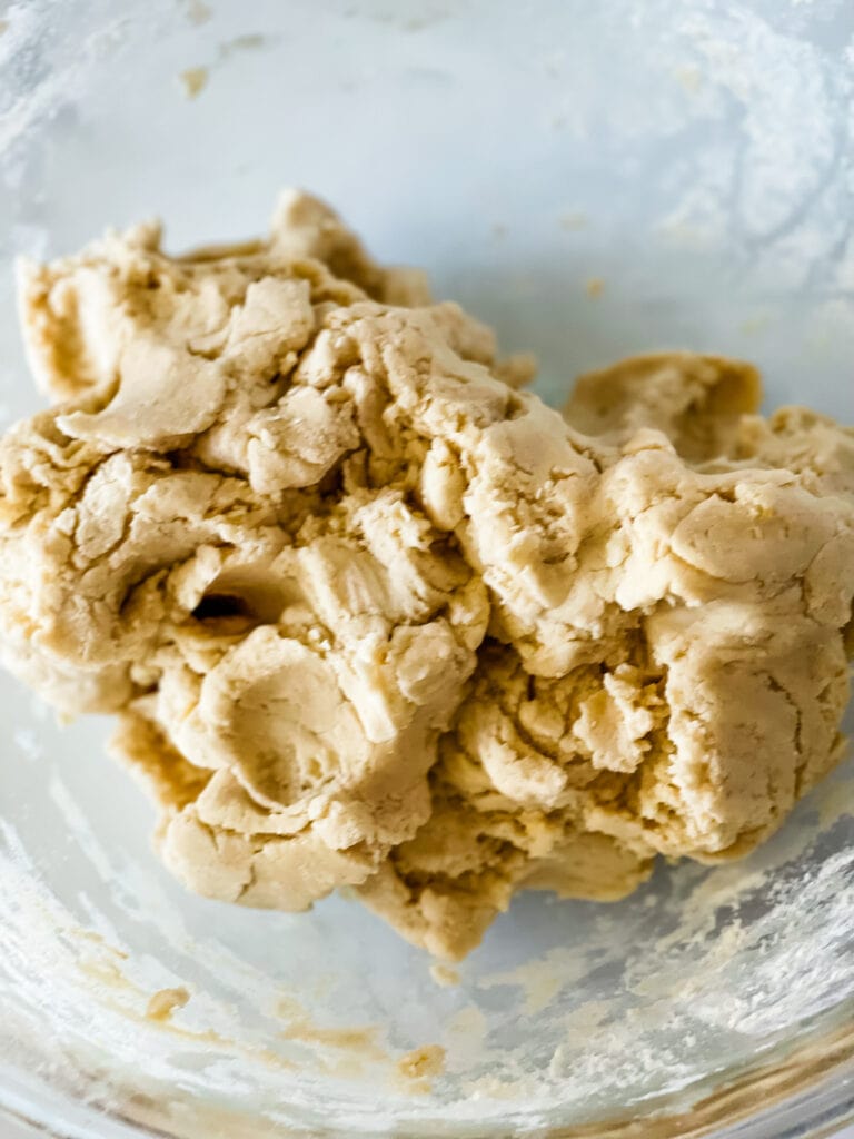 The sugar cookie dough in a bowl ready to refrigerate.