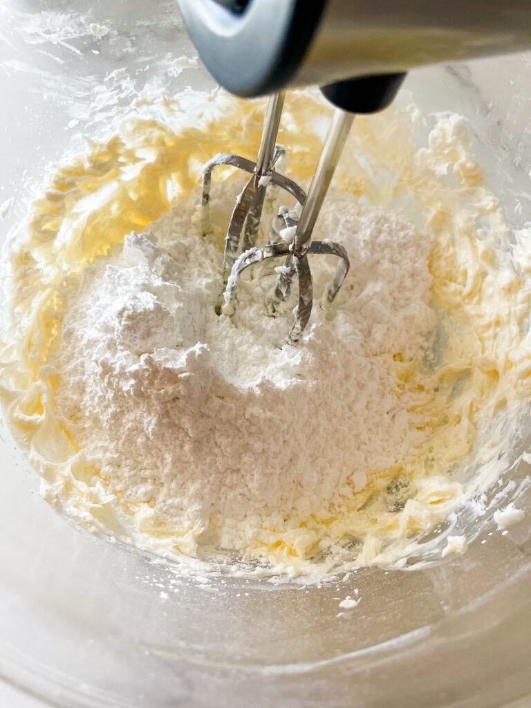 Beating in the powdered sugar.