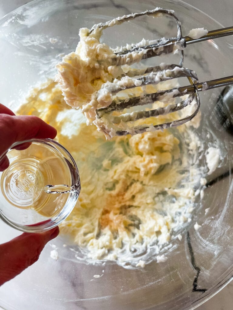 Creamed butter in the bowl with beaters and adding the extracts.