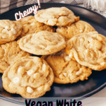 Black plate with vegan white chocolate macadamia nut cookies with gray checked cloth and glass of oat milk in the rear with pinterest text overlay.