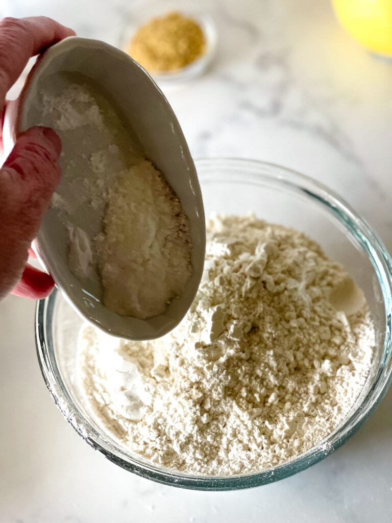 Adding the dry ingredients to the measured flour.