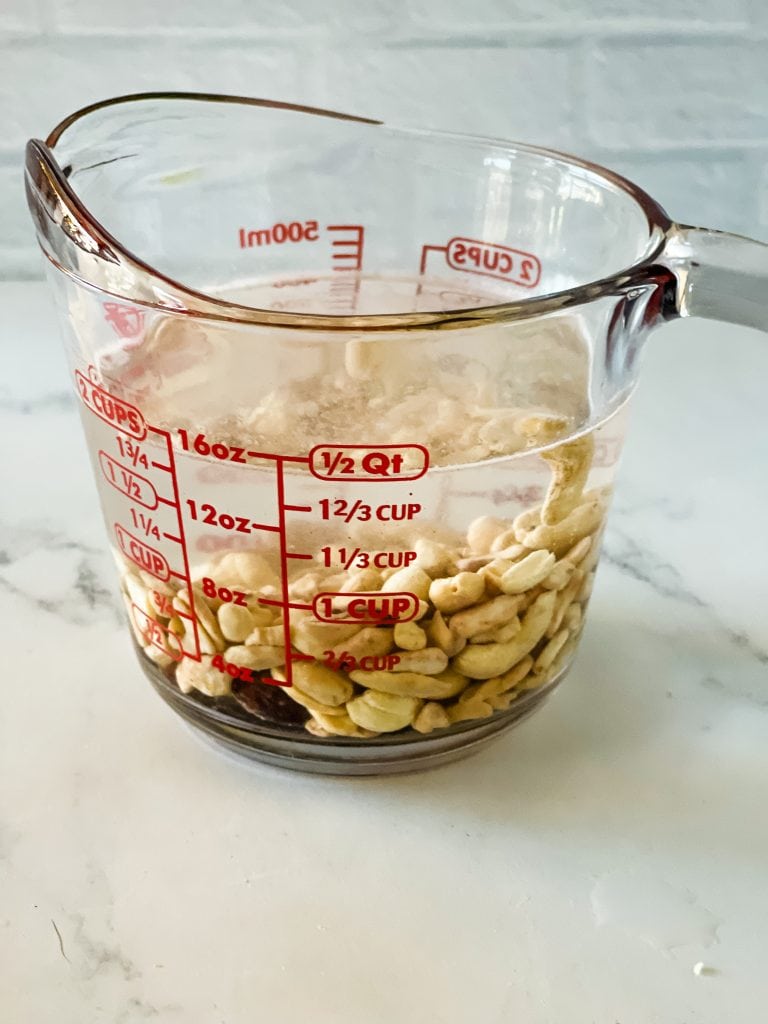 Soaking the cashews in the two cup glass measuring cup.