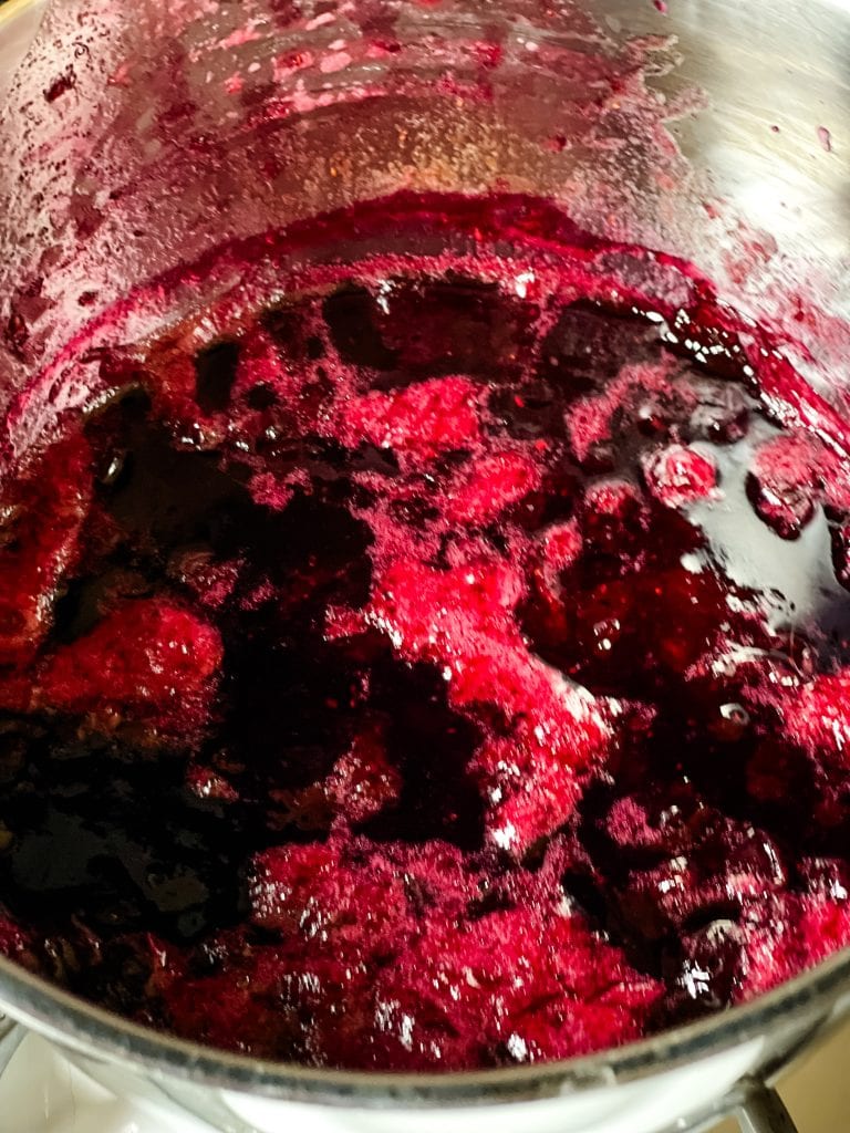 showing the little bit of foam on top of the cooked triple berry jam.