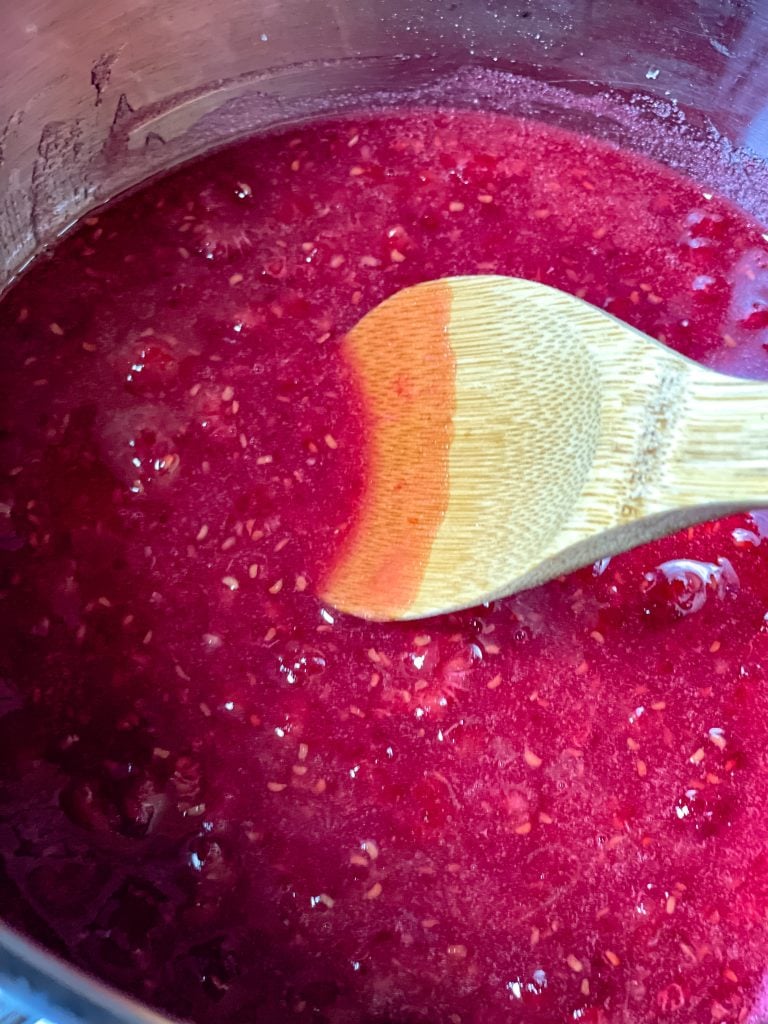 Stirring the raspberry mixture as it is cooking.