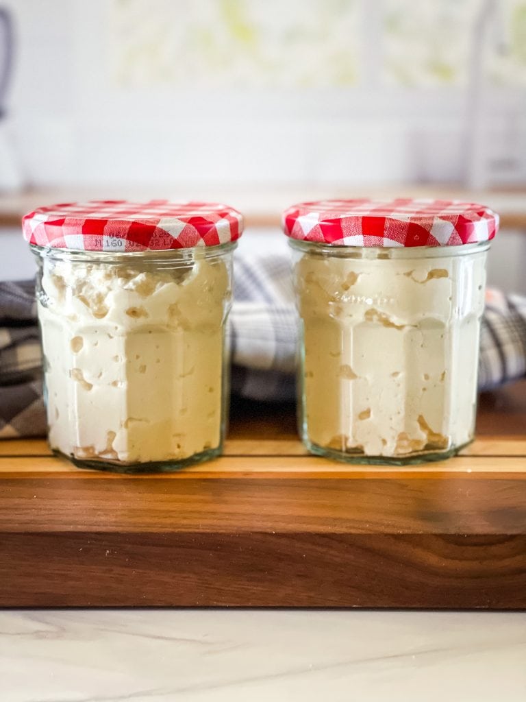 Two jam jars filled with vegan greek yogurt.