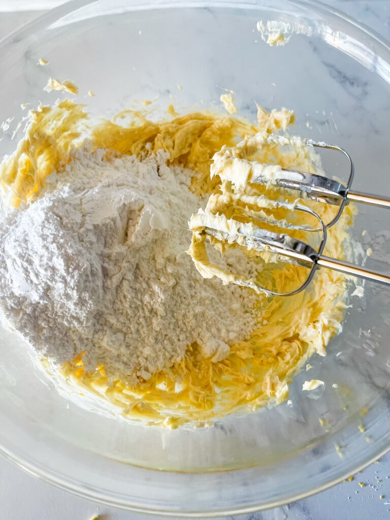 Adding powdered sugar to the beat vegan butter and shortening.