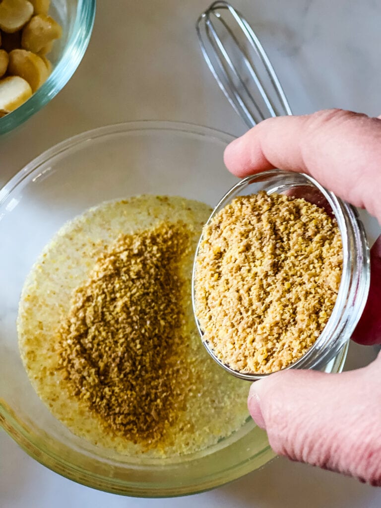 Adding ground flax seed to the water.