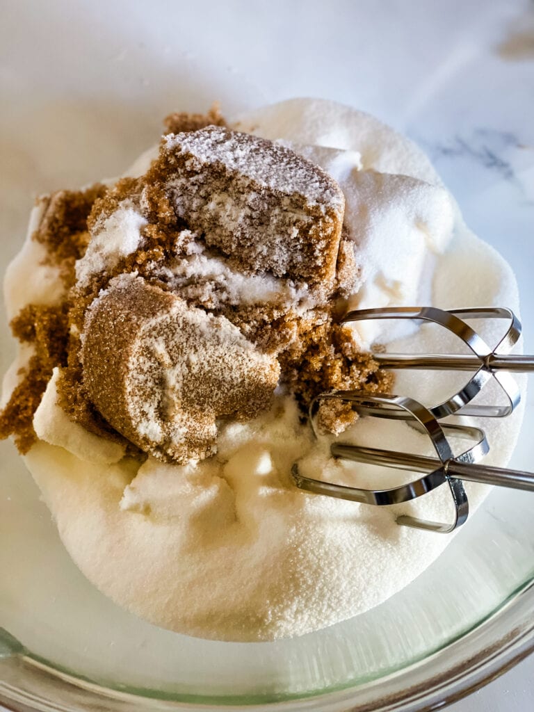 The fat and sugar in a bowl with beaters ready to cream together.
