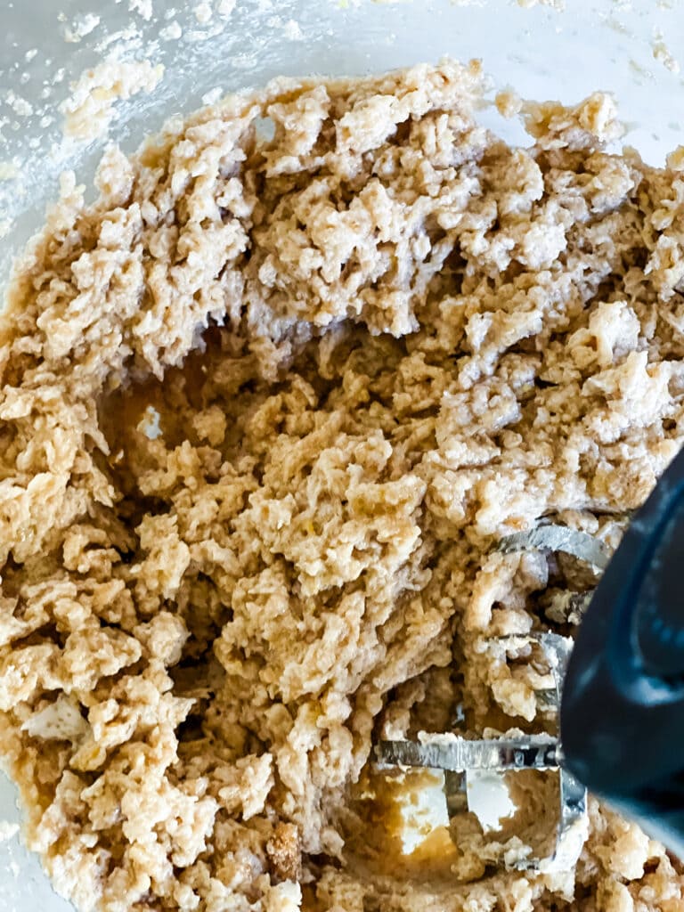 Mixing the cookie dough with the wet ingredients.