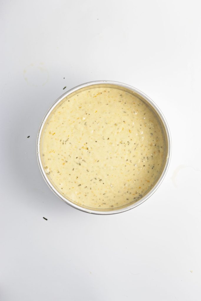 The olive oil orange cake is in the pan unbaked and ready for the oven.