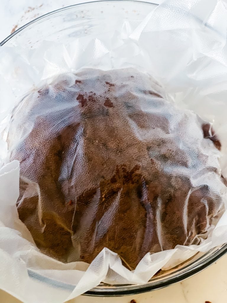 Covering the top of the chocolate peanut butter cookie dough with plastic wrap.