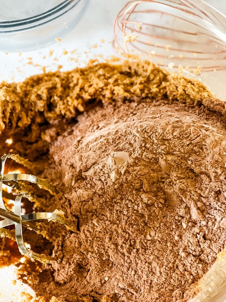 Mixing the dry ingredients into the wet ingredients.