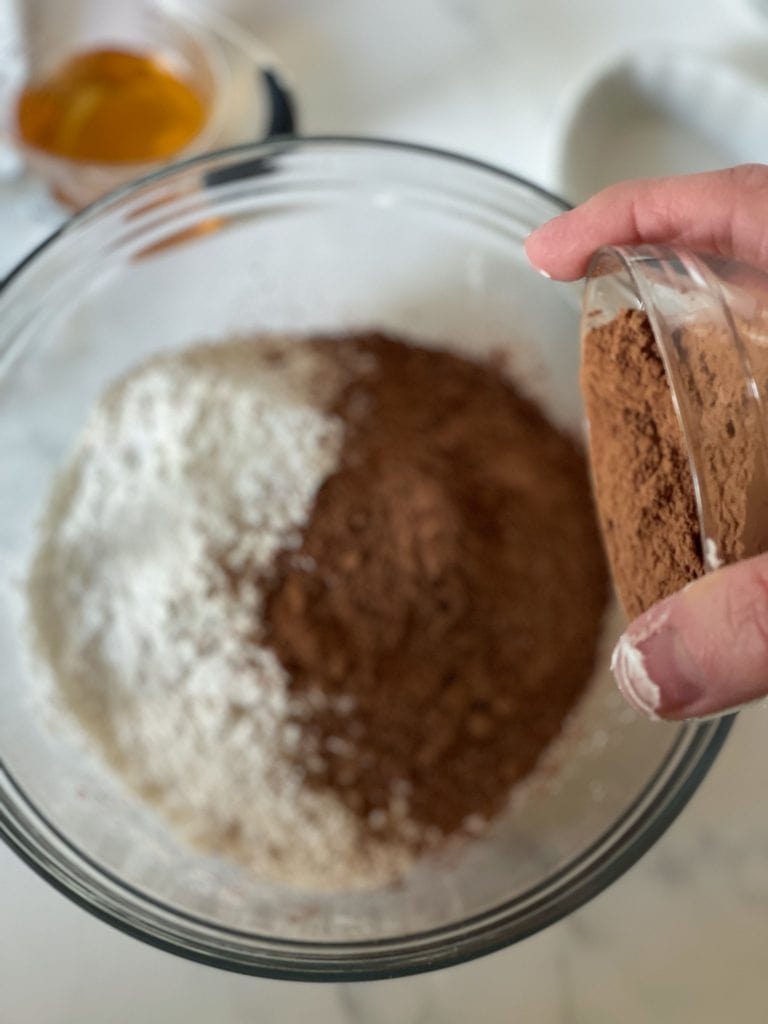 Adding the cocoa powder to the other dry ingredients.