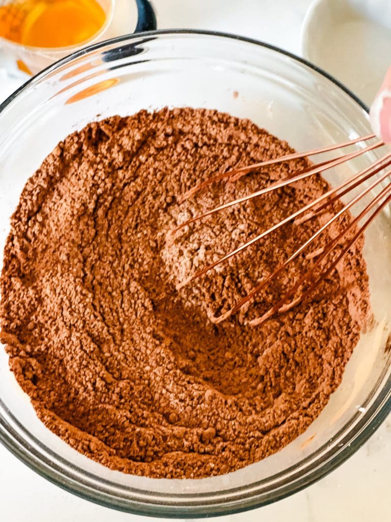 Mixing together the dry ingredients including the cocoa.