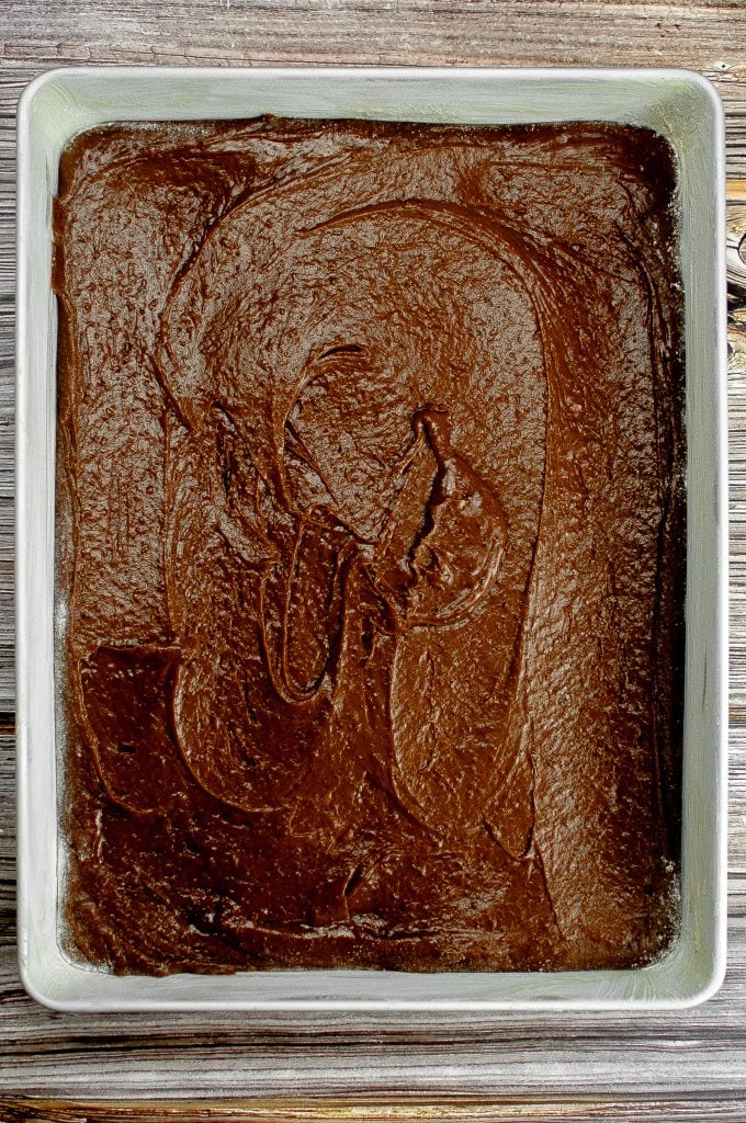 The cake mixture has been poured and smoothed in the cake pan and is ready for baking.