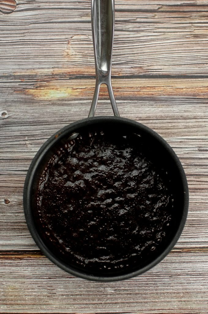 Adding the cocoa to the melted vegan butter.