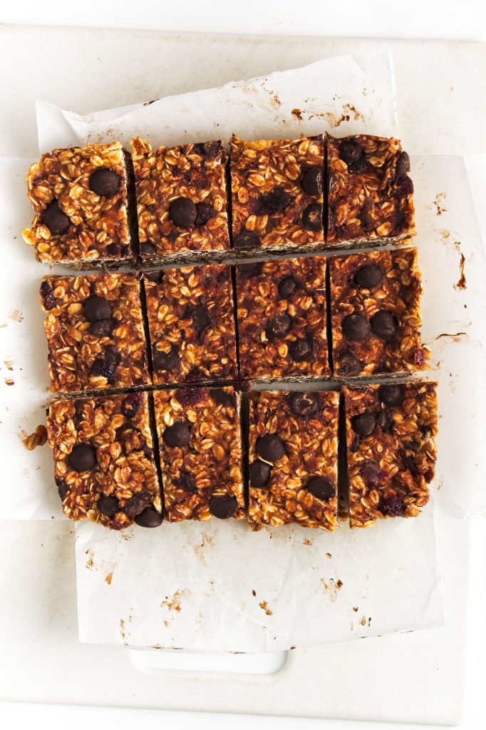 the cut peanut butter oat bars on a piece of white parchment paper