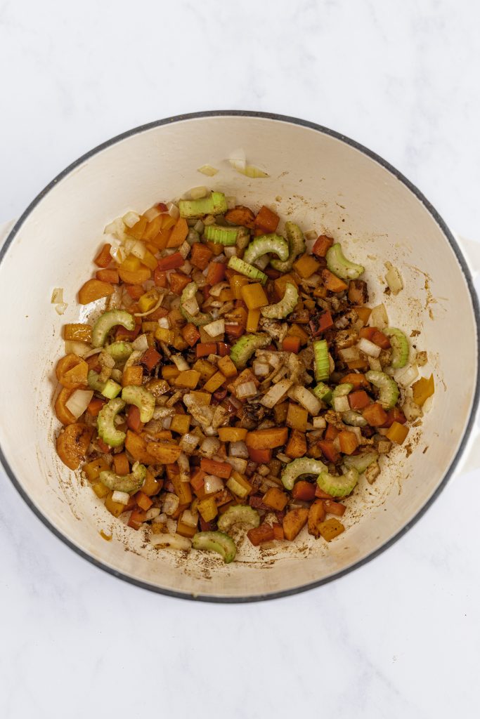 Sautéed colorful chopped vegetables in a white pot, perfect for healthy veggie recipes.