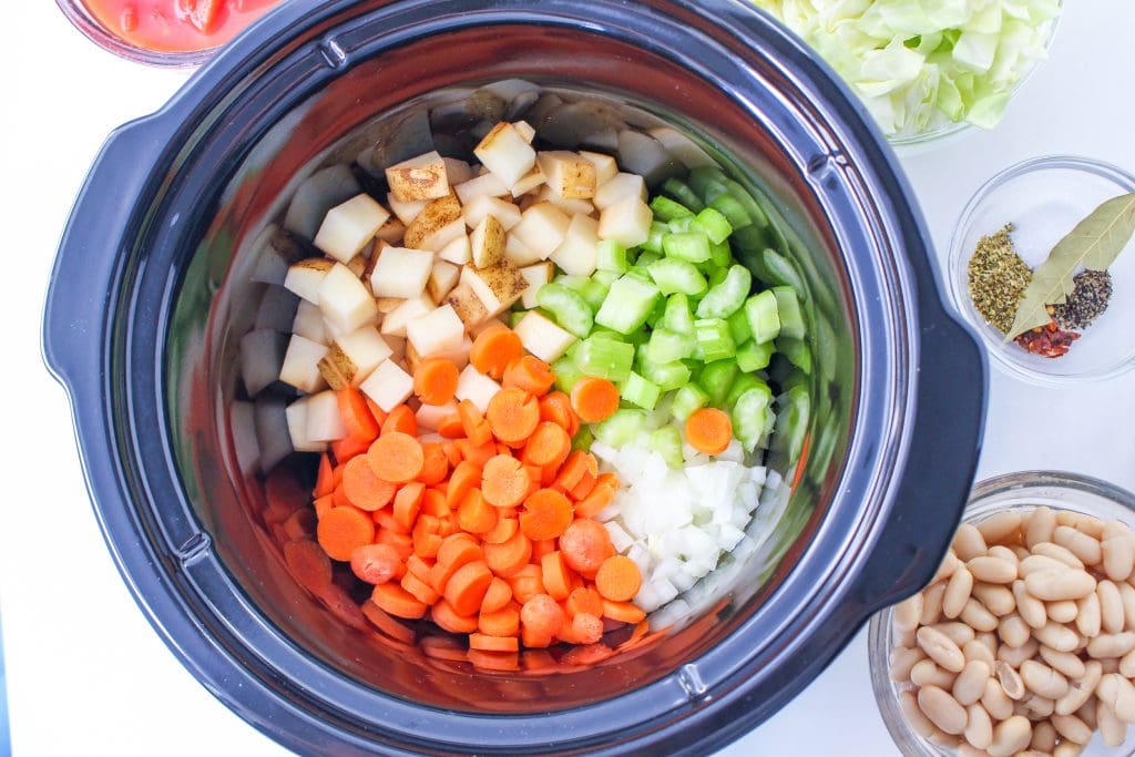 cut vegetables in the crock pot with seasonings, beans, canned tomatoes and cut cabbage on the side.