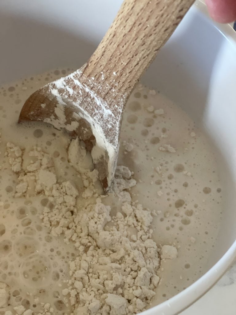 Stirring the dry ingredients and the wet ingredients of the pancake batter