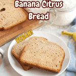 Two slices of banana citrus bread on a white plate, labeled “Vegan.” A loaf and ingredients like flour and bananas are nearby. The text reads “Bread Maker Bread—Banana Citrus” with a “veggie FUN kitchen” logo at the bottom.