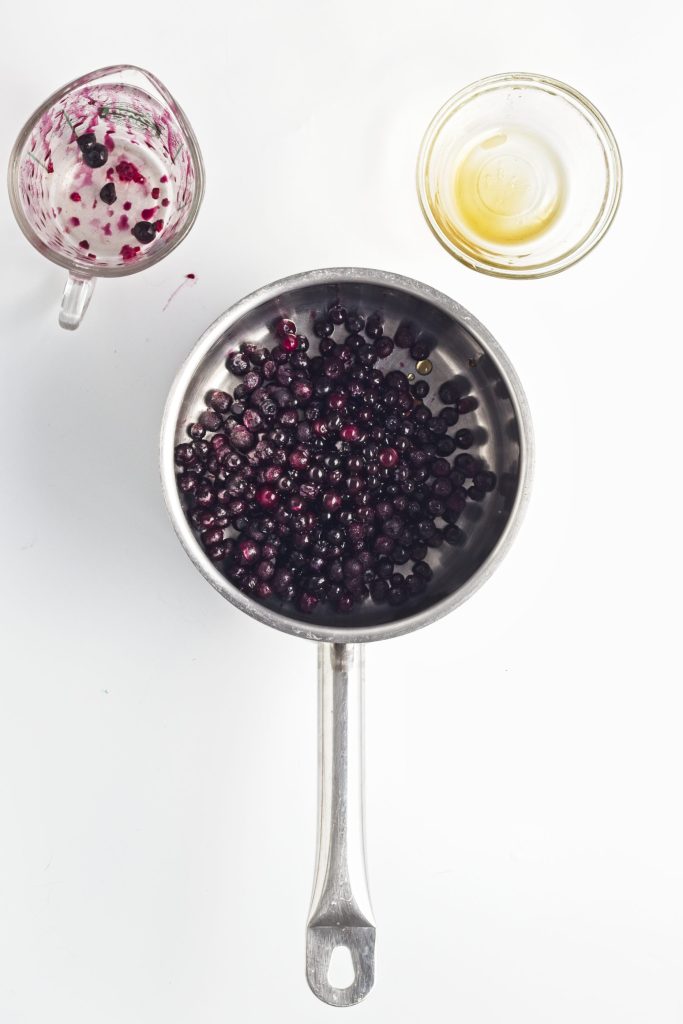 blueberries in a pan cooking with maple syrup