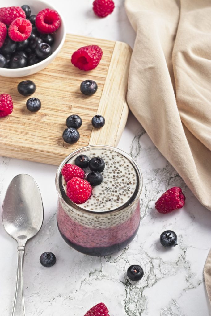 Fresh berry chia pudding topped with raspberries and blueberries. Ideal healthy vegan snack from Veggie Funk Kitchen.