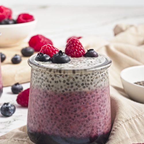 Fresh berry chia pudding topped with raspberries and blueberries. Ideal healthy vegan snack from Veggie Funk Kitchen.