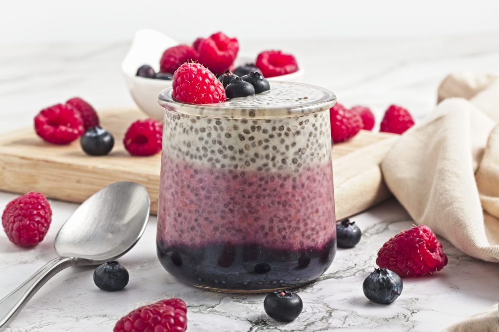 Fresh berry chia pudding topped with raspberries and blueberries. Ideal healthy vegan snack from Veggie Funk Kitchen.