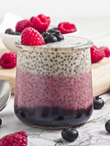 Fresh berry chia pudding topped with raspberries and blueberries. Ideal healthy vegan snack from Veggie Funk Kitchen.