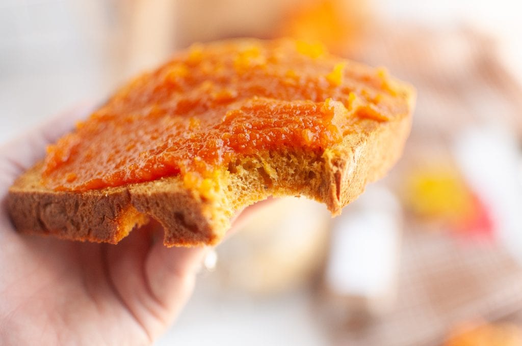 a slice of vegan pumpkin bread with pumpkin jam topping, healthy breakfast idea.