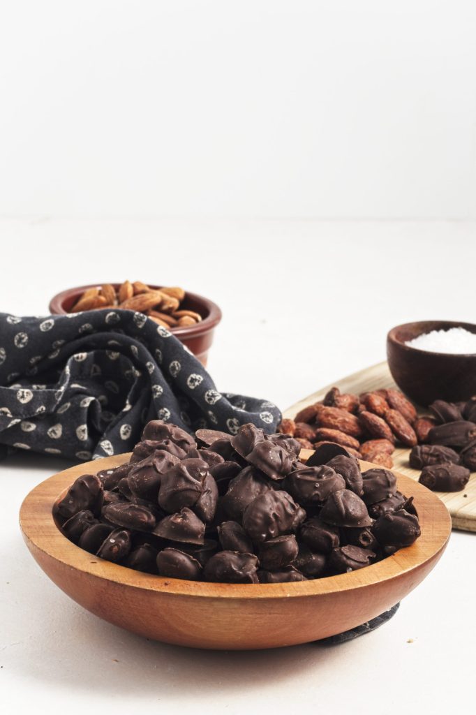 Wooden bowl of chocolate covered almonds
