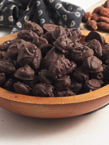 Wooden bowl with chocolate covered almonds