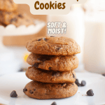 A square plate with a stack of four pumpkin cookies in the center with a plate of more in the top left corner. Almond milk in glasses top right corner. Cute fall decor surrounding. with Pinterest text overlay.