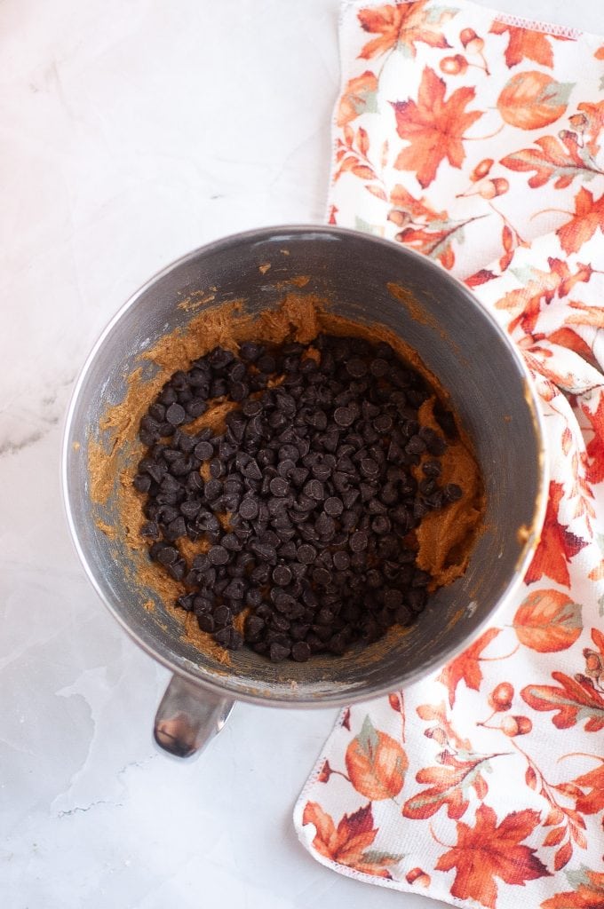 Mixing in the vegan chocolate chips for vegan pumpkin cookies