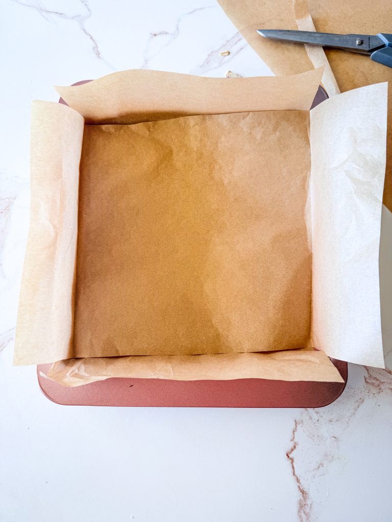 8x8 pan showing the proper way to place the parchment paper