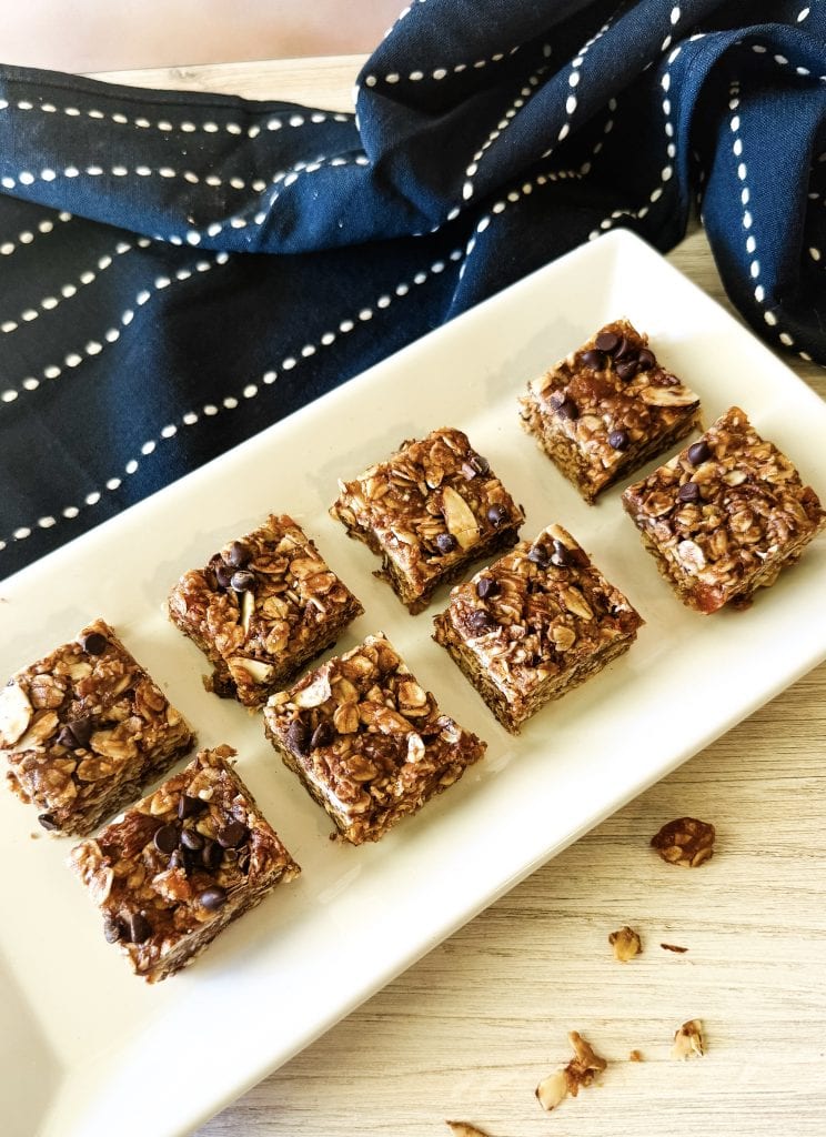 Delicious no-bake oatmeal energy bites with chocolate chips on a white platter.