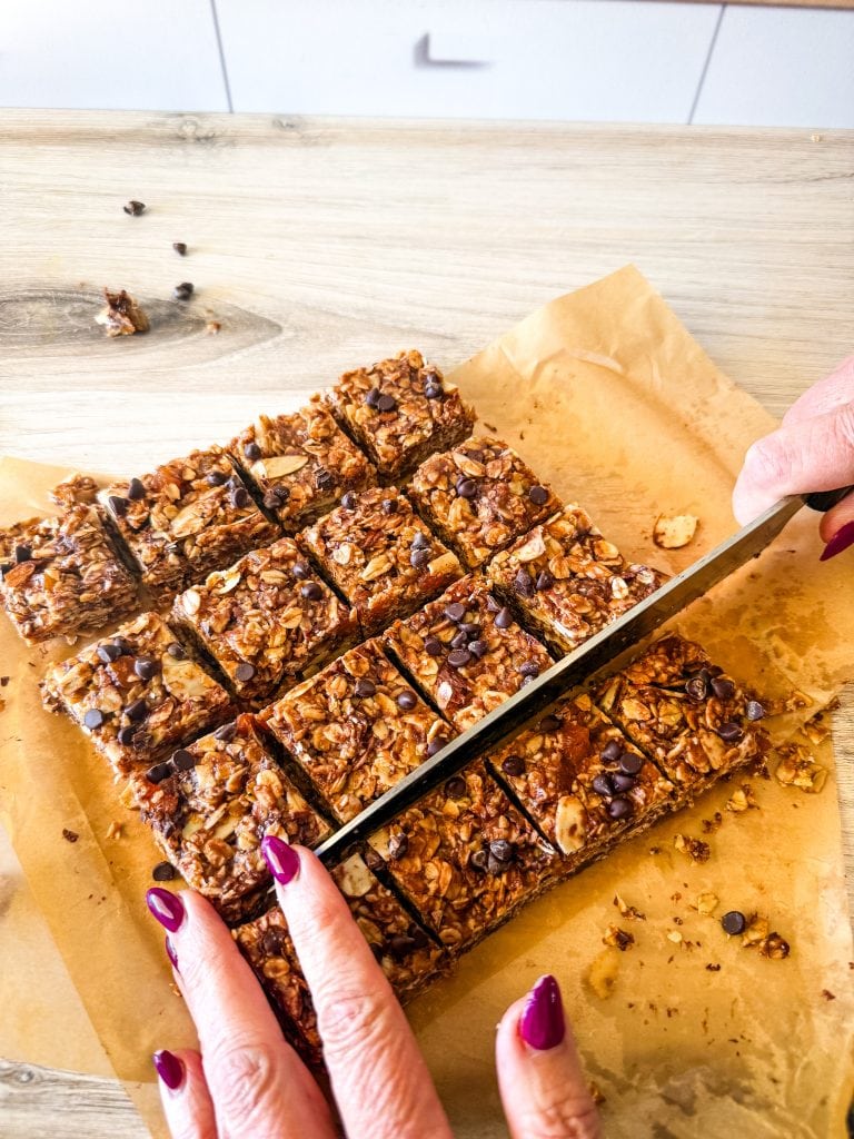 Delicious homemade granola bar slices on parchment paper. Healthy vegan snack ideas from Veggie Fun Kitchen.