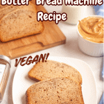 Two slices of yeasted peanut butter bread on a white plate, with a loaf and more slices on a wooden board, a bowl of peanut butter, and text overlay reading Yeasted Peanut Butter Bread Machine Recipe VEGAN!.