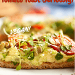 A close-up of vegan avocado tomato toast topped with seeds and microgreens on whole grain bread. Text reads: The BEST Avocado Tomato Toast (Seriously) VEGAN! with a veggie FUN kitchen logo at the bottom.